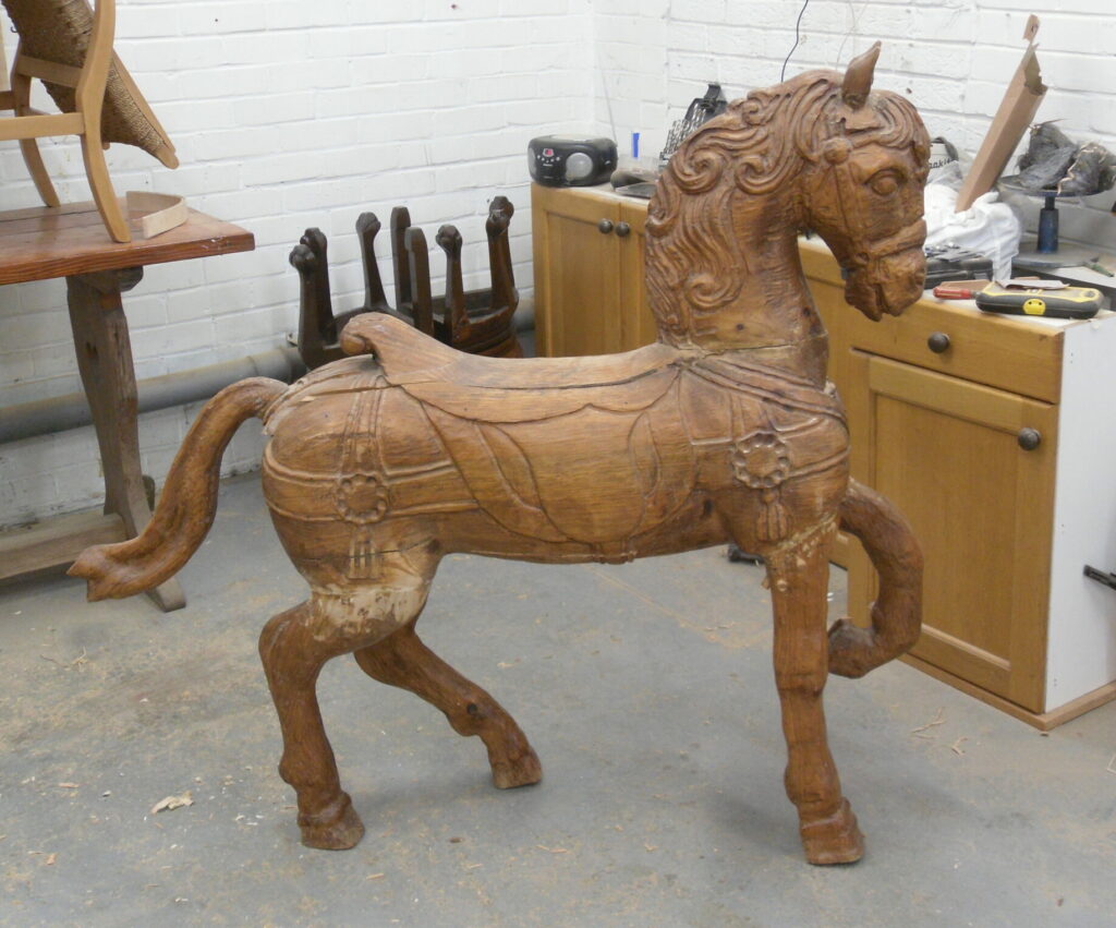 Carved wooden horse before restoration