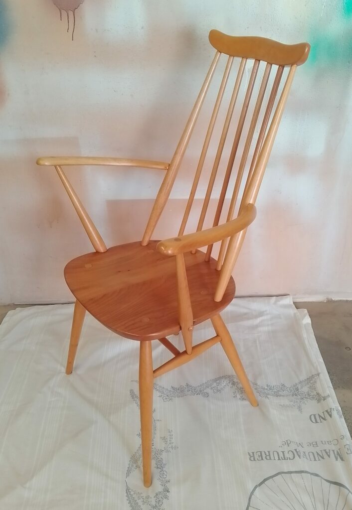 Side view of restored Ercol Goldsmith chair with elegant wooden frame
