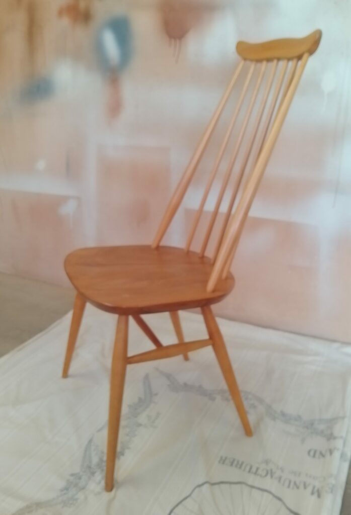 Side view of restored Ercol Goldsmith chair with elegant wooden frame