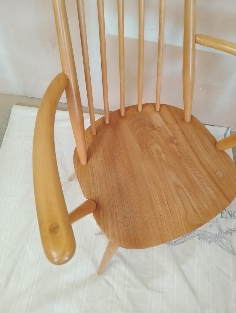 Close-up of Ercol Goldsmith chair showing curved wooden back and craftsmanship