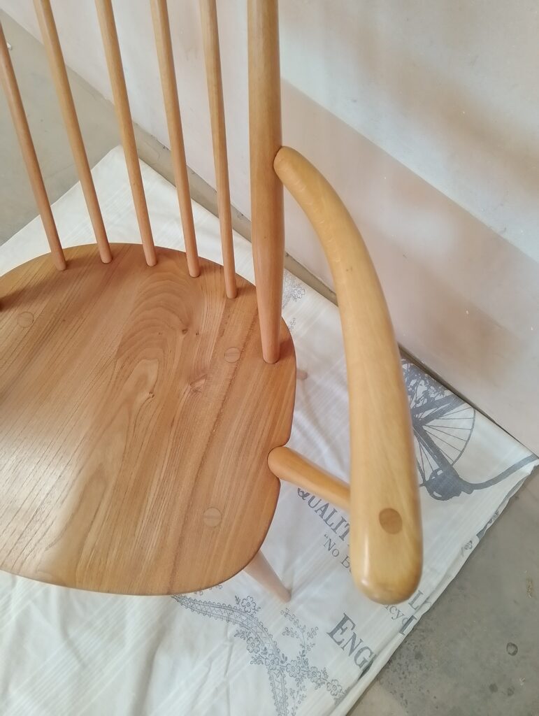 Close-up of Ercol Goldsmith chair showing curved wooden back and craftsmanship