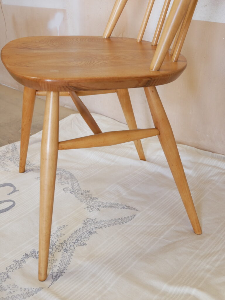 Detail of restored Ercol Goldsmith chair with elegant wooden frame